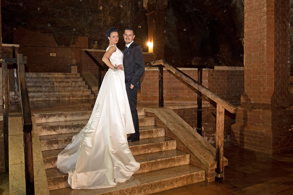The bride and groom in the old salt works underground