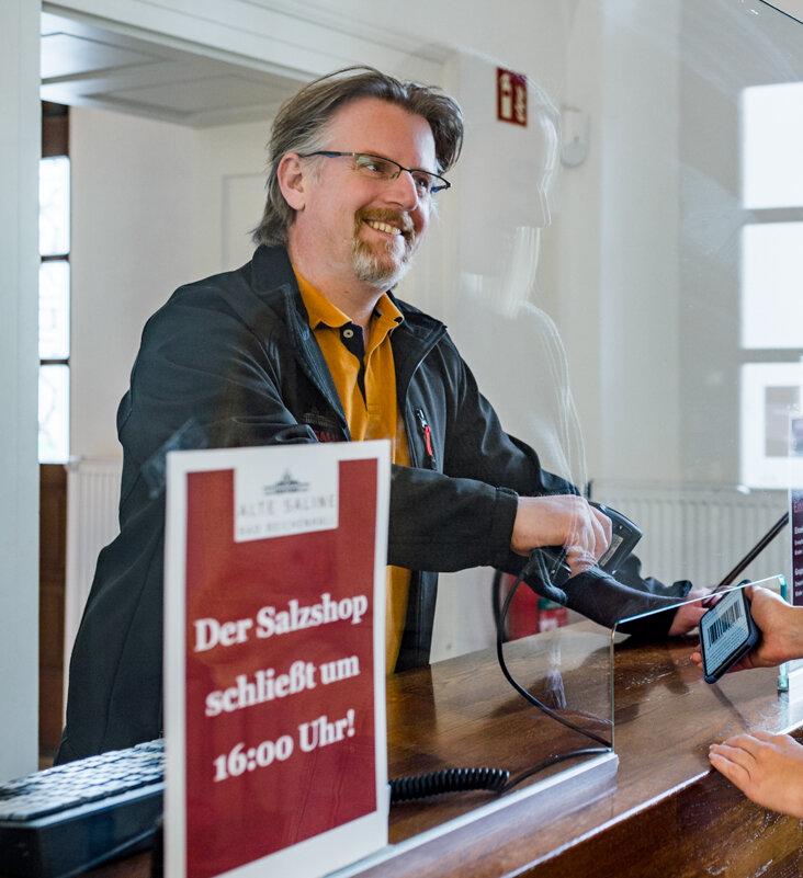 Cashier greets a visitor at the cash desk